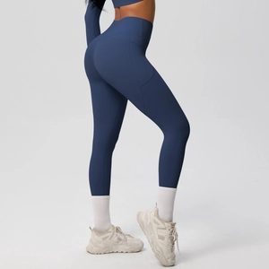 Detail view of high waisted navy yoga pants with side pockets and slimming tummy control