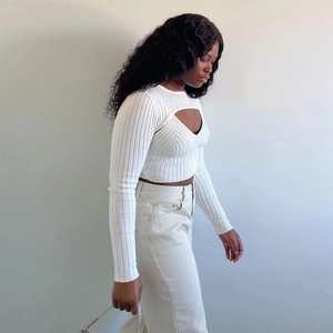 Detail of white ribbed knit top featuring unique hollow-out design and slim fit long sleeves