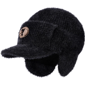 Detail of black faux fur trapper hat featuring a round brown leather logo patch on the side