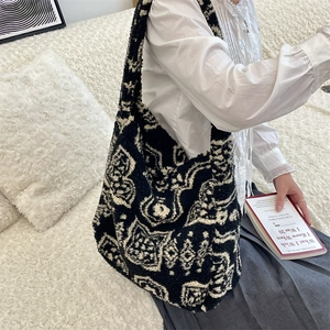 Detailed close-up of high-capacity plush tote bag with black and white bohemian patterns