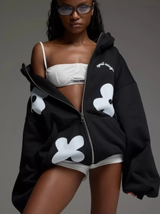 Detailed view of heavy cotton zip-up hoodie with white floral prints and silver zipper