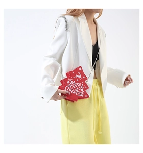 Detail view of a red Christmas tree shaped crossbody bag with a silver chain strap