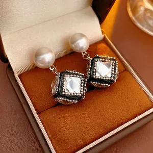 French vintage cubic pearl drop earrings with crystal center in a brown jewelry box
