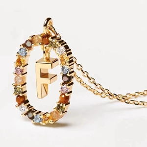 Golden letter F necklace pendant with multi-color zircon stones on a white background