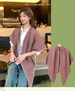 Detail of a brown and white checkered knit shawl showing texture and cafe lifestyle styling