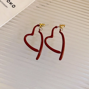 Detailed view of matte burgundy heart-shaped hollow earrings with gold accents