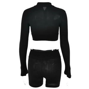 Back view of black ribbed knit two-piece set with long sleeve crop top and high waist shorts