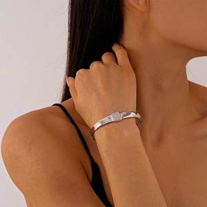 Macro detail of silver geometric bracelet with sparkling crystal inlay on rectangular clasp