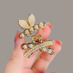 Mini gold butterfly and knot hair claws with white pearls and chain details