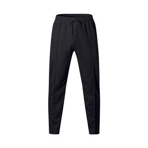 Detail of black baggy sweatpants with elastic drawstring waist and front pleated seams
