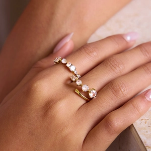 Elegant gold titanium steel ring with sparkling zircon stones worn on model's hand