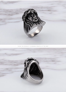 Detailed macro of vintage stainless steel pirate ring with intricate facial textures
