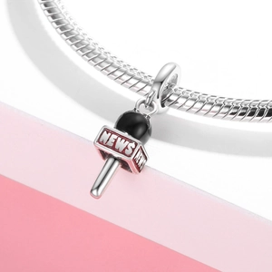 S925 sterling silver microphone charm with red NEWS enamel on a woven bracelet