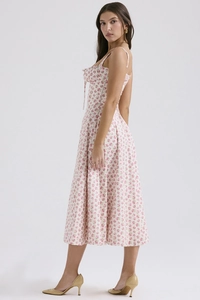 Detail view of pink floral midi dress featuring delicate strap and chest tie design