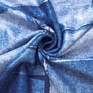 Close-up of blue and white vintage denim print fabric with soft spiral pleats