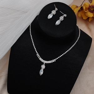 Detail of silver bridal jewelry set with sparkling zircon floral and teardrop pendants