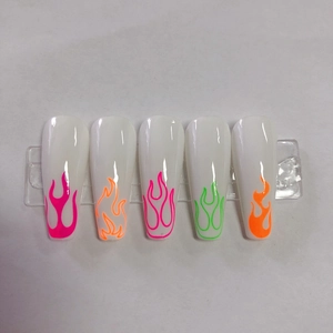 Detailed view of long coffin false nails with white base and colorful flame patterns