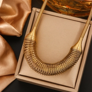 Luxurious 18K gold plated spring coil choker necklace on elegant silk background