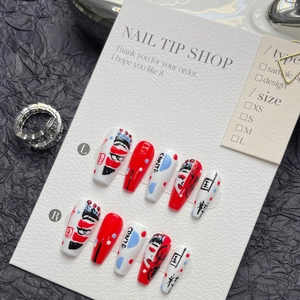 Detailed view of hand-painted Peking Opera face art nails on black textured background
