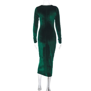 Detail of emerald green velvet dress showing slim fit silhouette and soft fabric texture