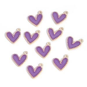 Close-up of ten purple enamel heart charms with golden beaded edges on white background