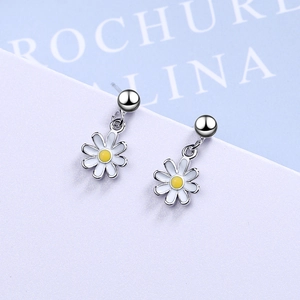 Sweet petite daisy dangle earrings with white enamel petals on a soft pastel background