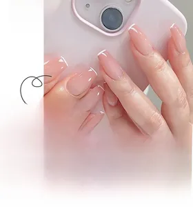 Close-up of French white tip press-on nails in long coffin shape with jelly pink base