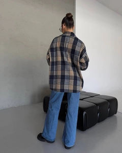 Rear view of long-sleeve plaid oversized shirt jacket with brown and white check pattern