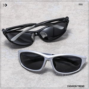 Detail view of black and silver polarized sports sunglasses on a marble surface