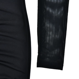Detail shot of the black dress showing contrast between solid fabric and sheer mesh mesh sleeve