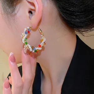 Colorful beaded hoop earrings with white pearls and multicolor crystals on gold hoops