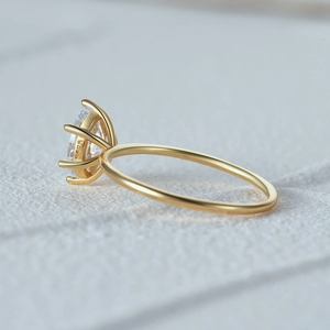 Detailed side view of 925 silver gold plated ring featuring six-prong moissanite setting
