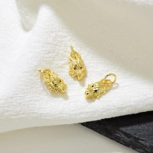 18k gold plated dragon head pendants with colorful zircon eyes on white fabric