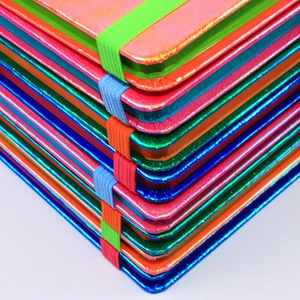 Close-up of laser holographic notebook stack with elastic straps in vibrant colors