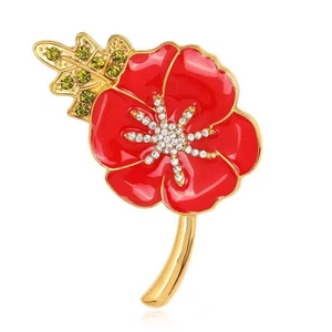Close-up of red enamel poppy brooch with gold trim and sparkling crystal rhinestones