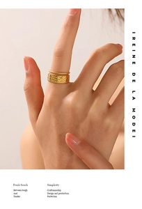 Detail of gold hammered stainless steel wide ring with delicate beaded edge decoration