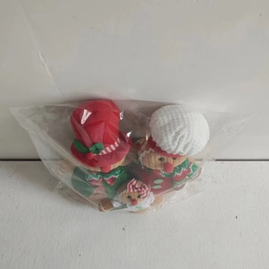 Three gingerbread plush dolls in festive red and green outfits for Christmas decor
