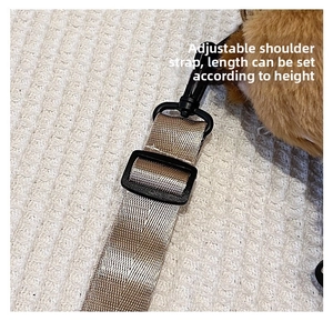 Detail of adjustable striped woven shoulder strap with black plastic buckle for plush bag