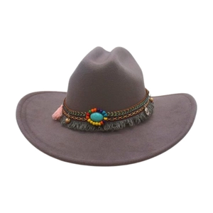 Détail d'un chapeau de cow-boy gris bohème avec perles ethniques et pompons roses