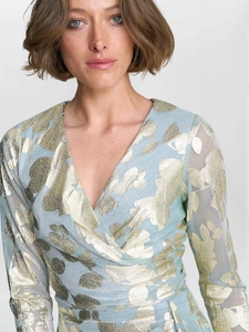 Close-up of light blue wrap dress with golden leaf jacquard and elegant V-neck detail
