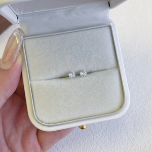 Macro shot of S925 sterling silver heart studs with zircons in a white velvet jewelry box