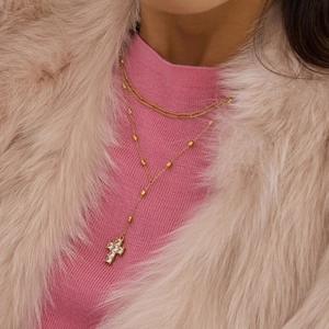 Double-layered 18k gold plated stainless steel necklace with zircon cross pendant on a model