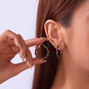 Detail of red and green twisted rope hoop earrings for Christmas festive style