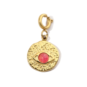 Detailed close-up of a gold hammered evil eye pendant with a pink center stone