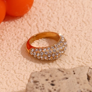 Detailed shot of 18K gold plated ring featuring a domed surface with pavé set crystals