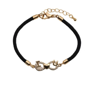 Detailed shot of black woven rope bracelet with gold infinity heart IU charm and zircons