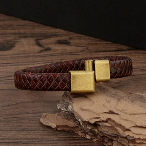 Handmade dark brown braided leather bracelet with vintage magnetic clasp on wood