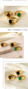 Detail of vintage 18k gold plated rings with green, tiger eye, and black agate stones