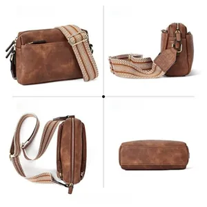 Detail view of brown pebbled leather crossbody bag with patterned woven shoulder strap