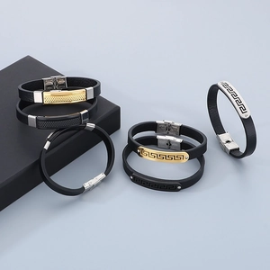 Detail of adjustable men's black leather bracelets with stainless steel clasps on a display box